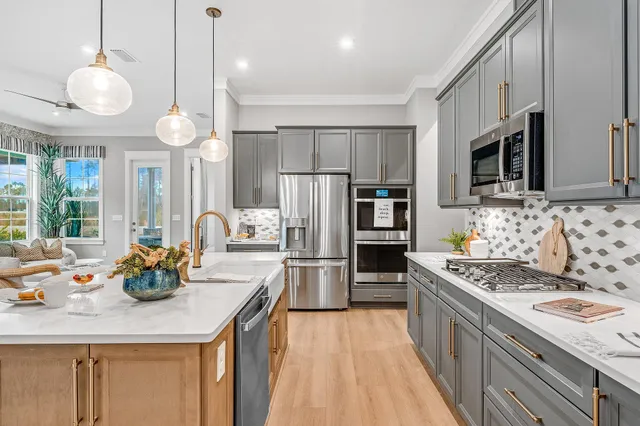 a kitchen with stainless steel appliances granite countertop a sink refrigerator and microwave