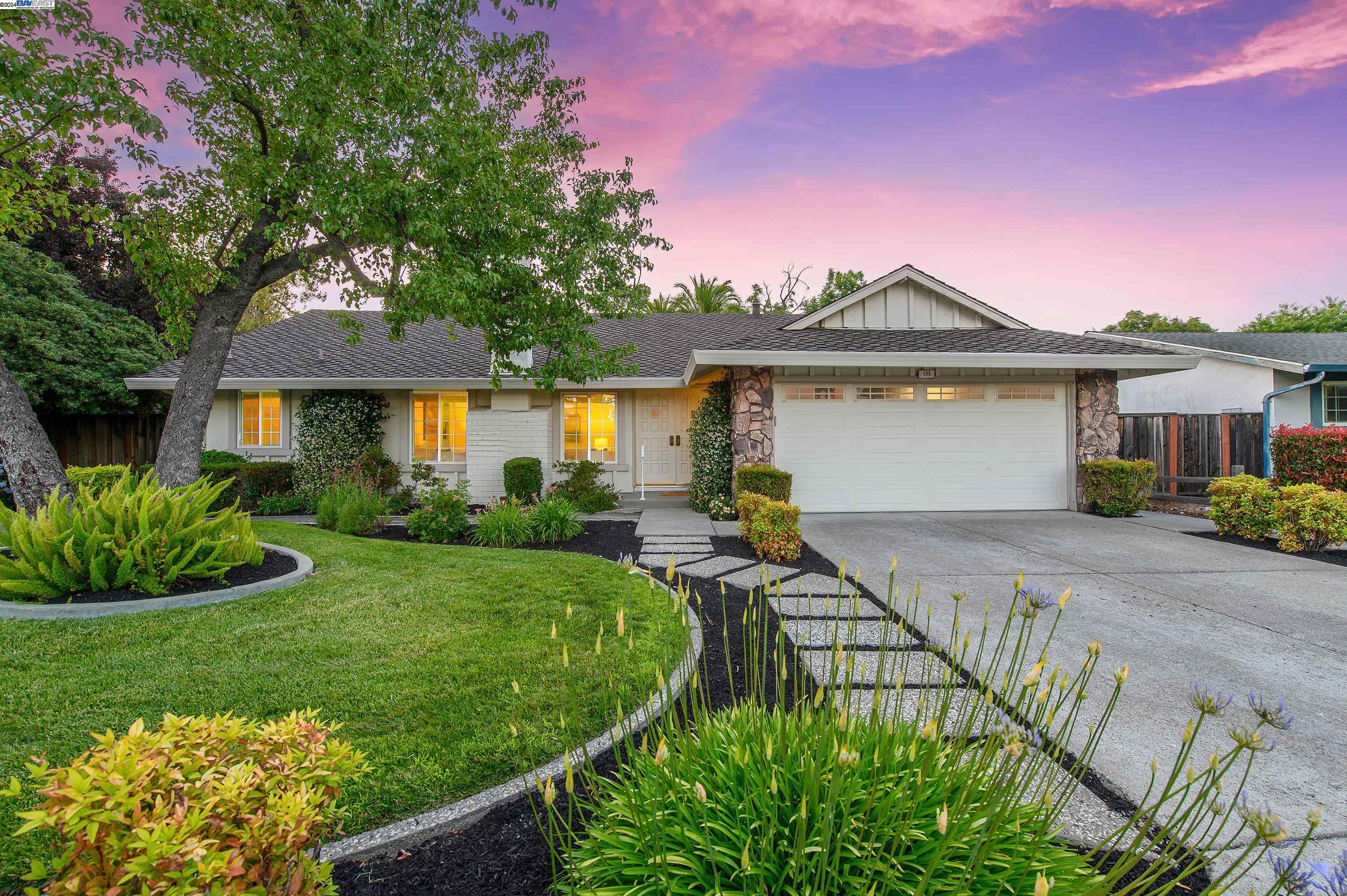 a front view of a house with garden