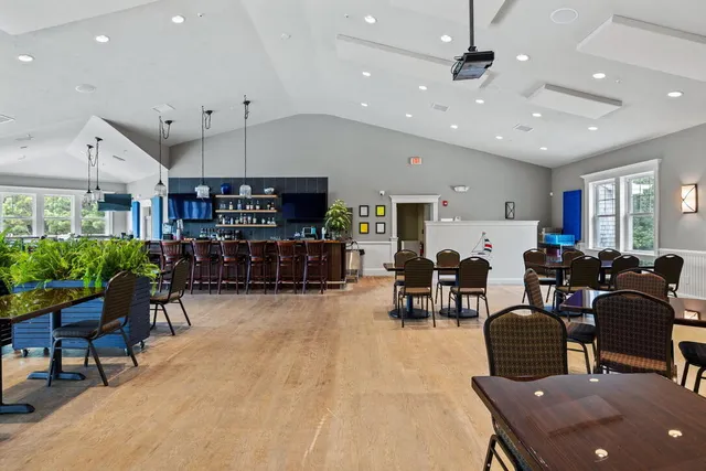 a living room with lots of furniture and kitchen view