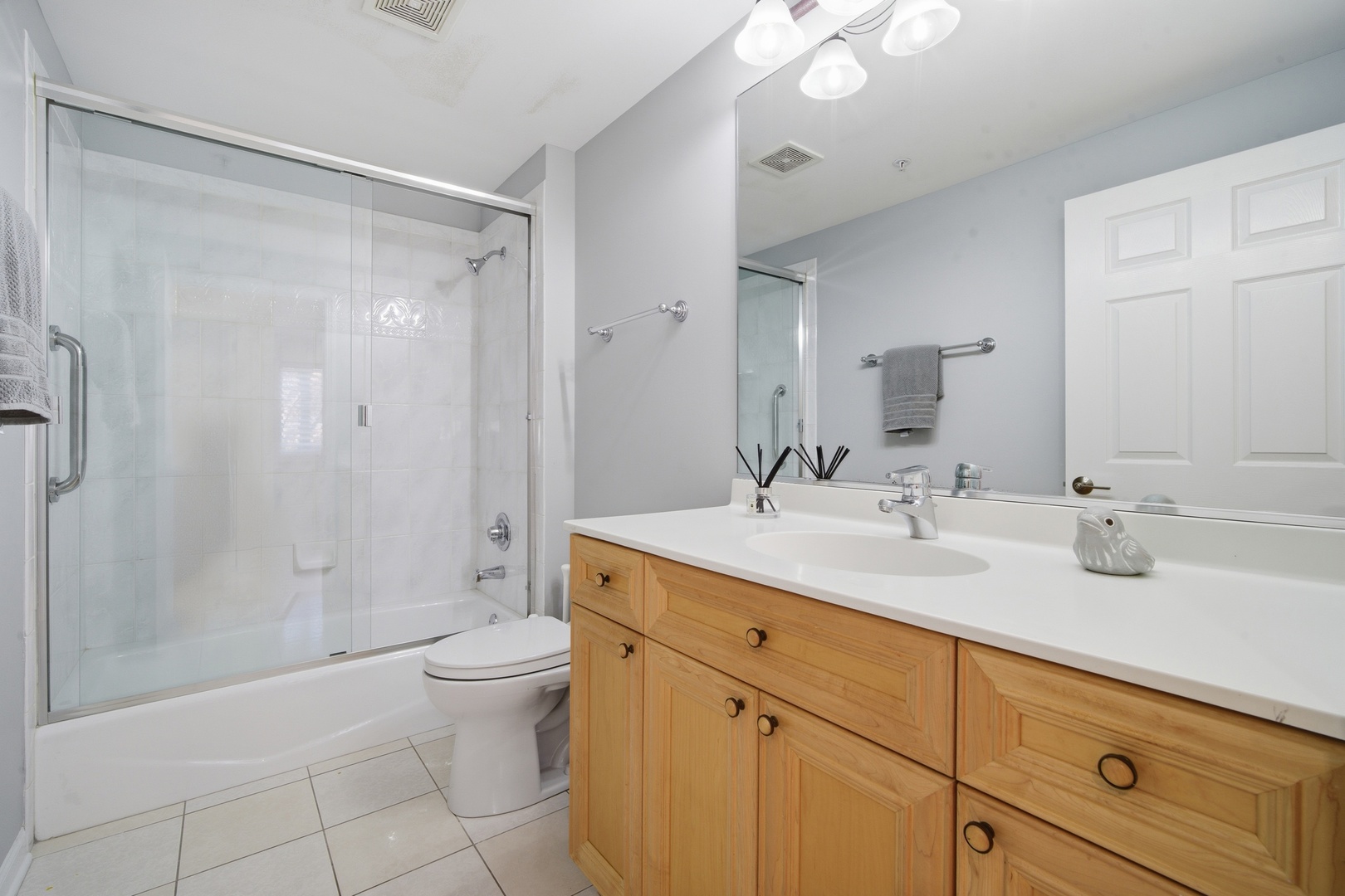 1688 Green Bay Road, Unit 204 Highland Park, IL 60035 - Photo 9 of 14 a spacious bathroom with a shower sink vanity mirror and toilet