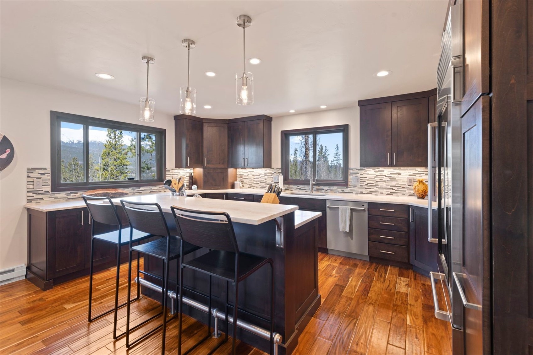 103 Bearing Tree Road Breckenridge, CO 80424 - Photo 12 of 30 a kitchen with a table chairs refrigerator and cabinets