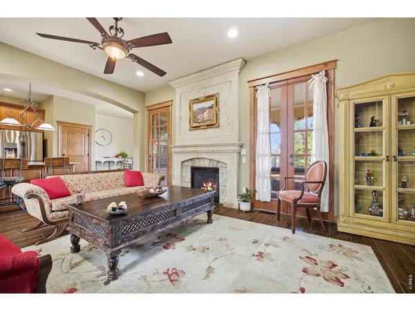 a living room with furniture kitchen view and a fireplace