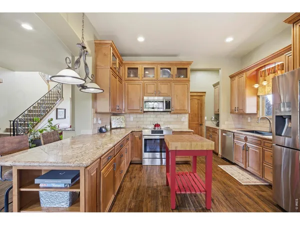 a kitchen with a refrigerator a sink and cabinets