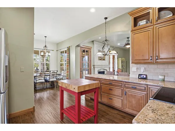 a kitchen with stainless steel appliances granite countertop a refrigerator and cabinets
