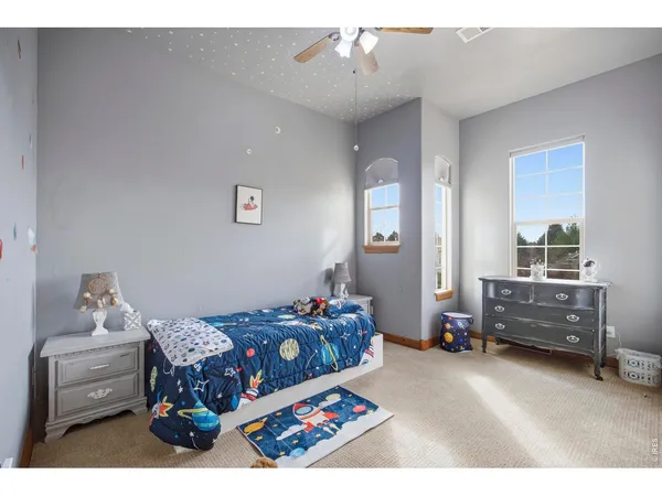 a bedroom that has a bed and a chair in it