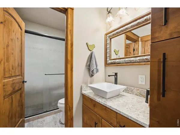 a view of an empty room and a kitchen