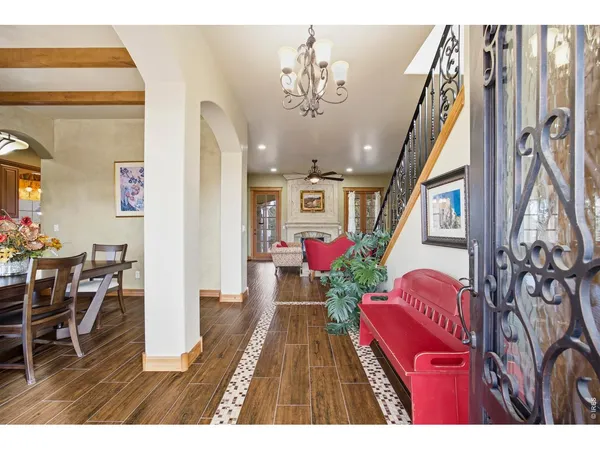 a living room with furniture fireplace and wooden floor