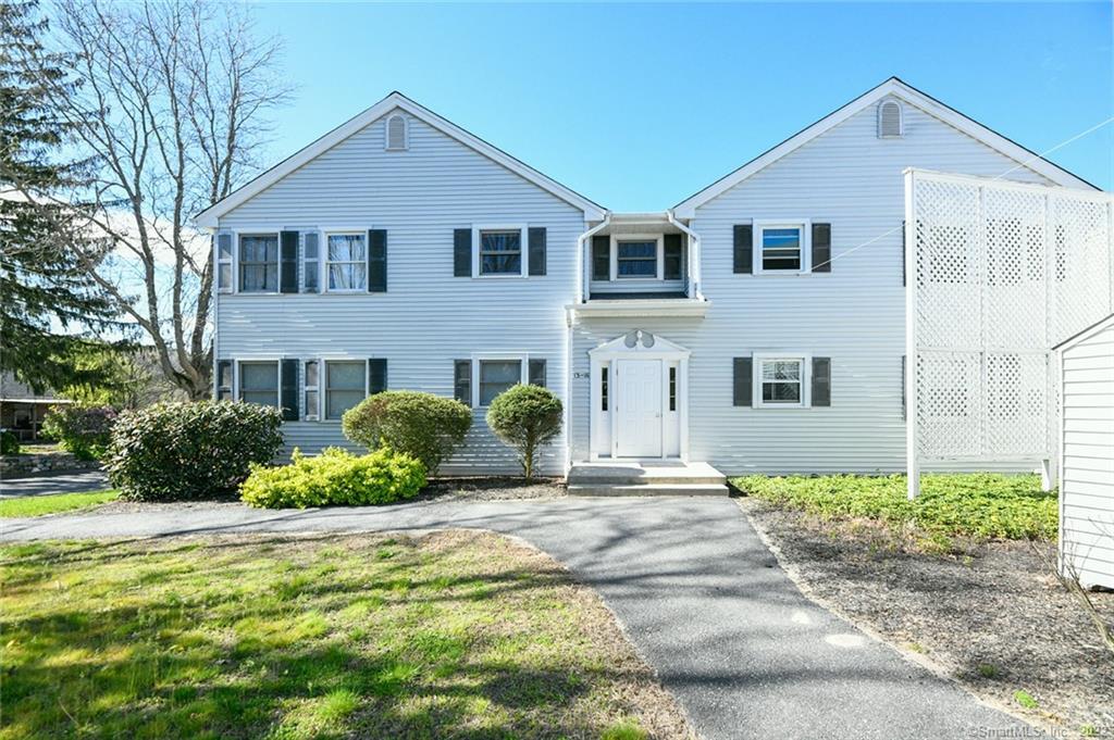 2 Perkins Street, Unit 14 Torrington, CT 06790 - Photo 1 of 1 a front view of a house with a yard and potted plants