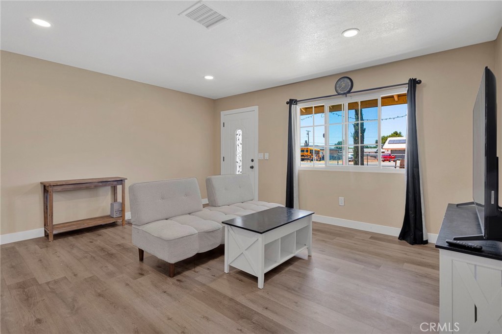 15471 Washoan Road Apple Valley, CA 92307 - Photo 7 of 38 a living room with furniture and a flat screen tv