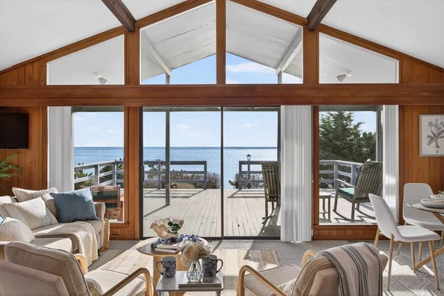 a living room with furniture and large windows