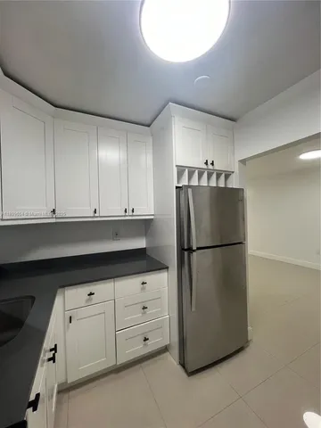 a white refrigerator freezer sitting in a kitchen