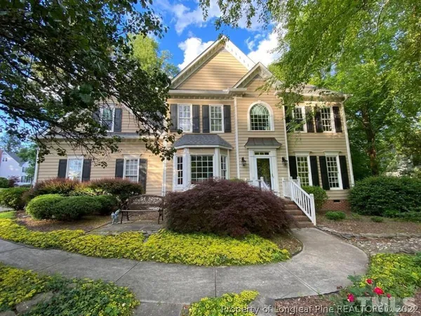 a front view of a house with a garden