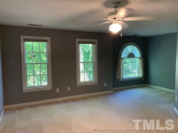 a view of a livingroom with a ceiling fan and window