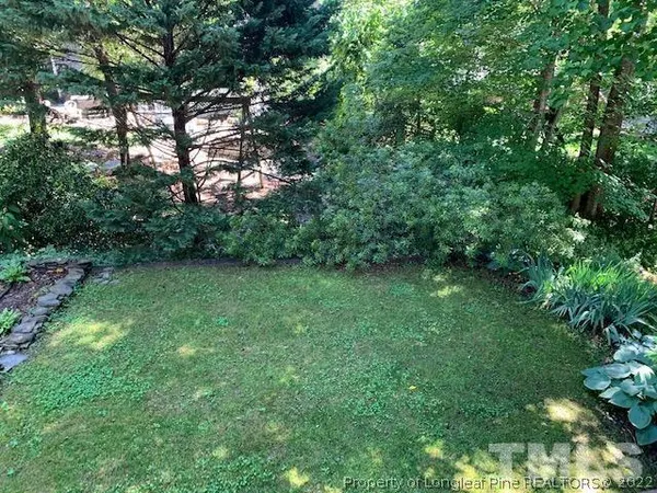 a view of backyard with deck and garden