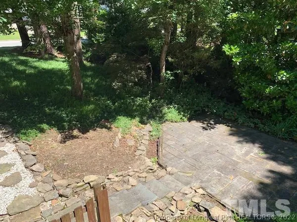 a balcony with wooden floor in front of it