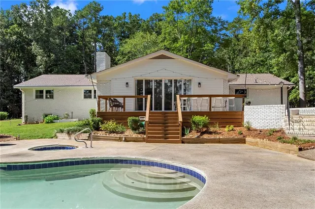 an aerial view of a house with a garden and lake view