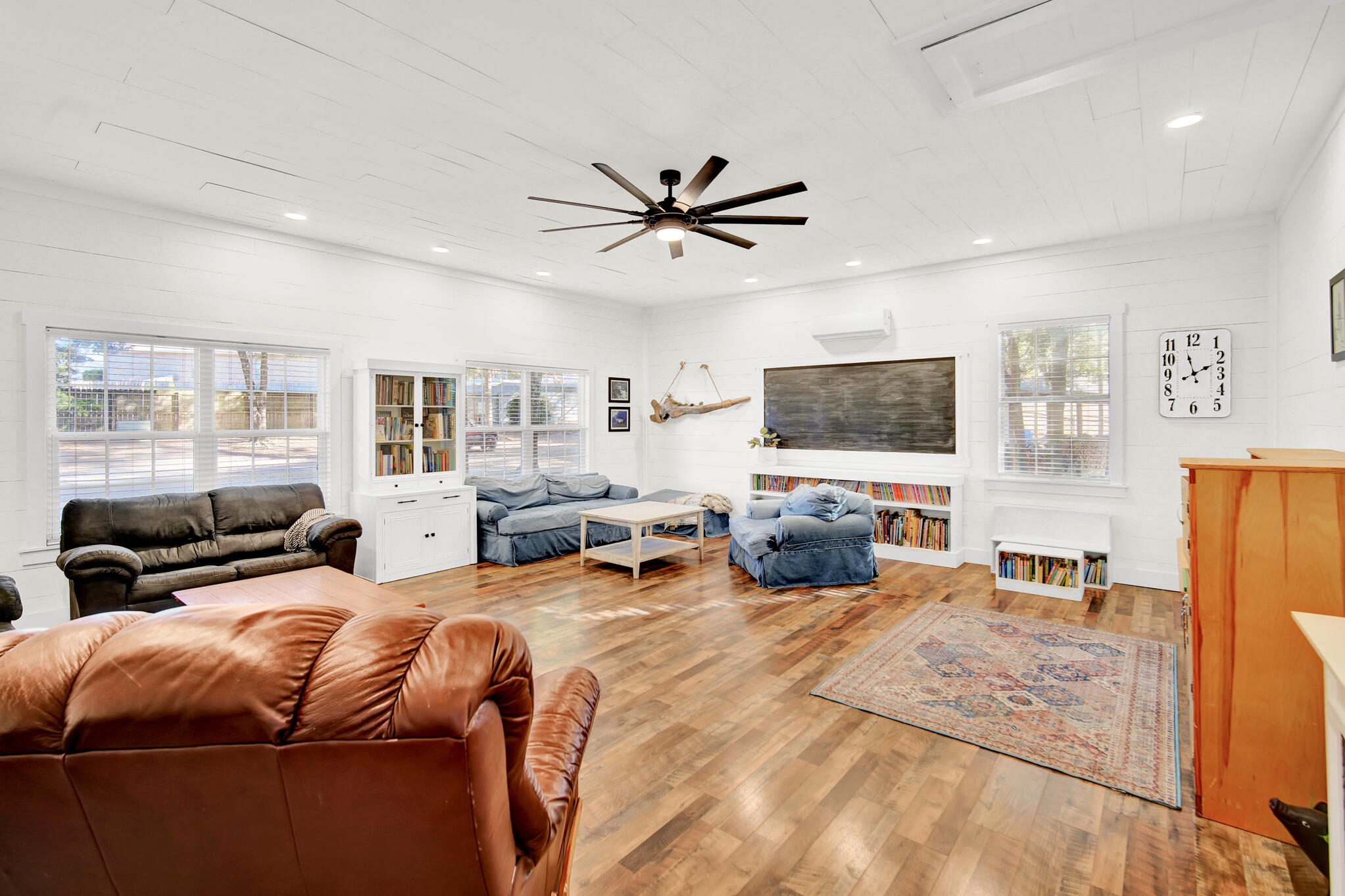 115 Steves Place Crestview, FL 32536 - Photo 23 of 66 a bedroom with a bed a couch and a flat tv screen