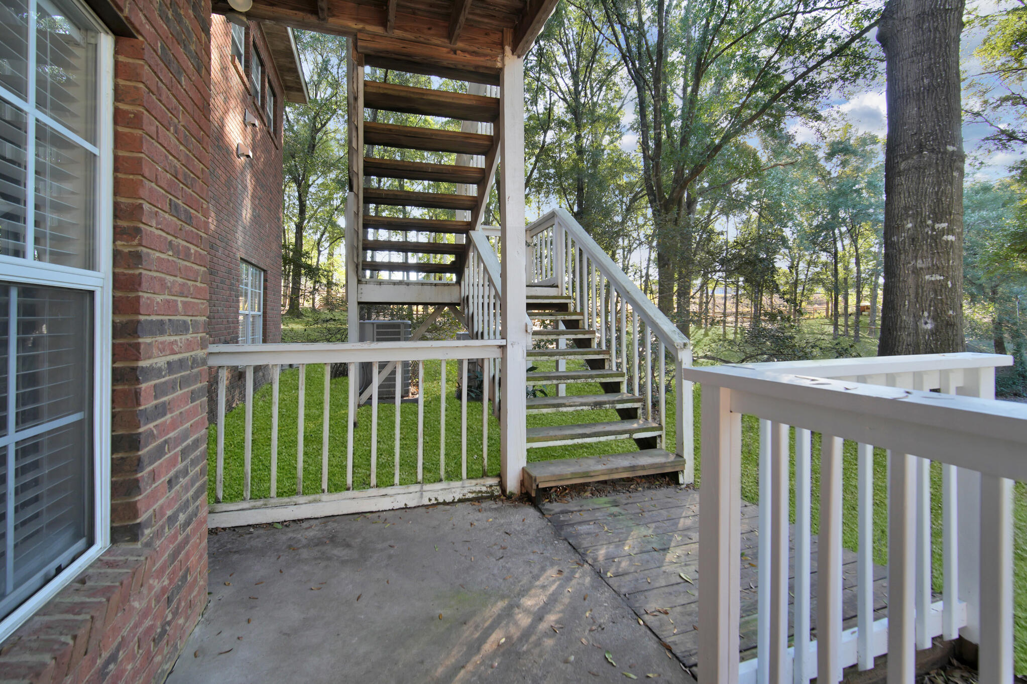 115 Steves Place Crestview, FL 32536 - Photo 5 of 66 a view of a house with a small yard and wooden fence and a large tree