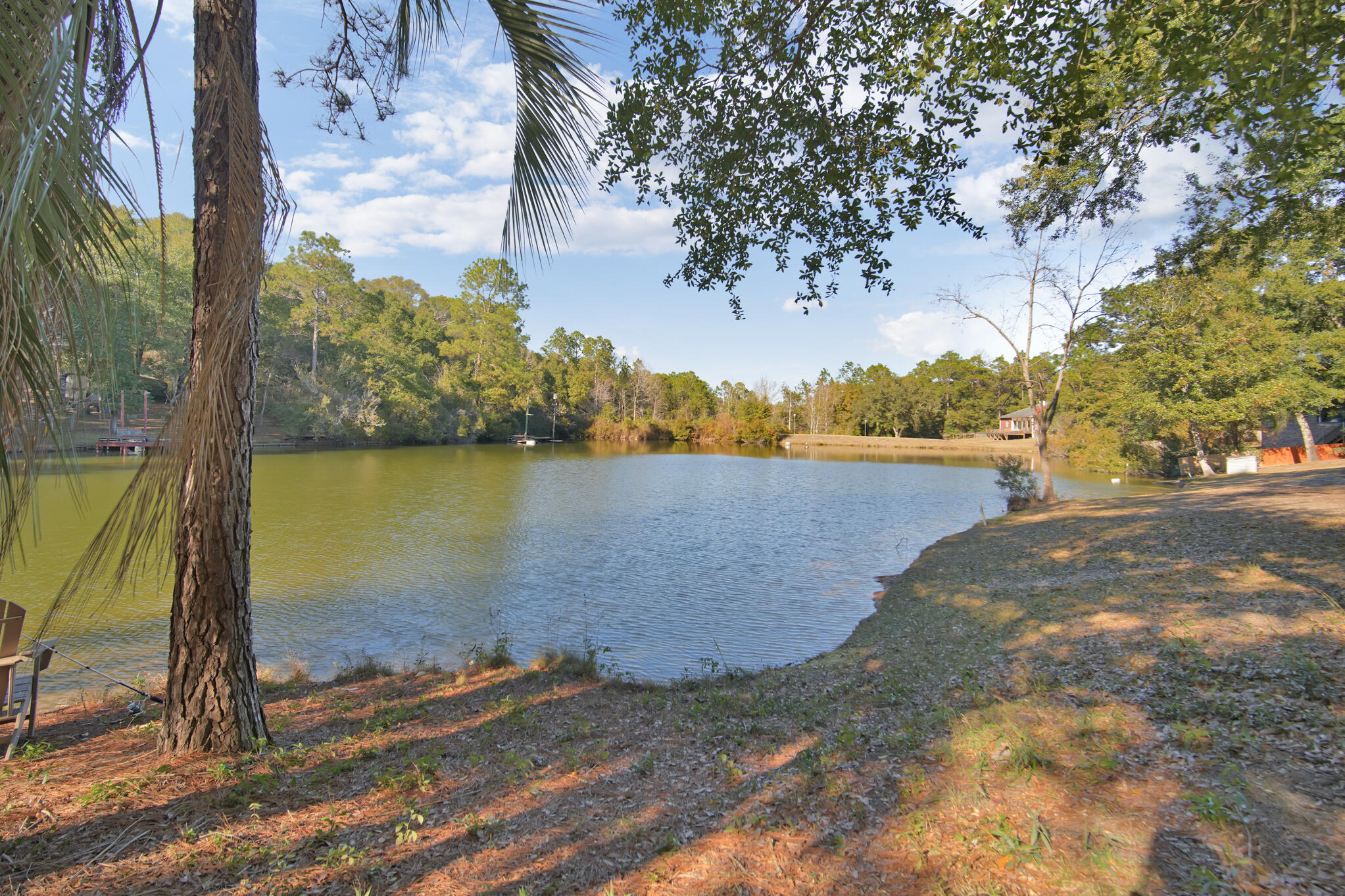 115 Steves Place Crestview, FL 32536 - Photo 57 of 66 a view of a lake with houses in the background