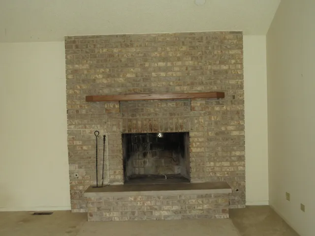 a kitchen with granite countertop a sink stove and refrigerator