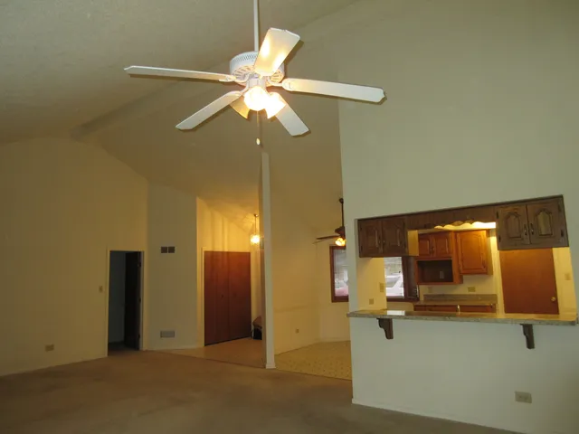 a kitchen with kitchen island a sink appliances and cabinets