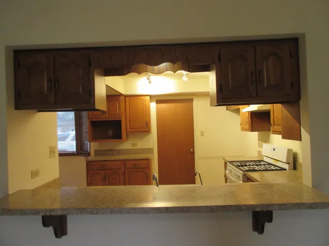 a view of room with a ceiling fan and wooden floor
