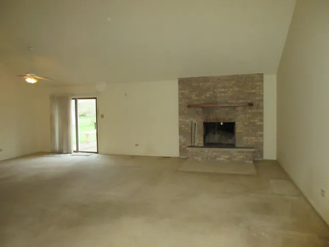 a view of empty room with a fireplace