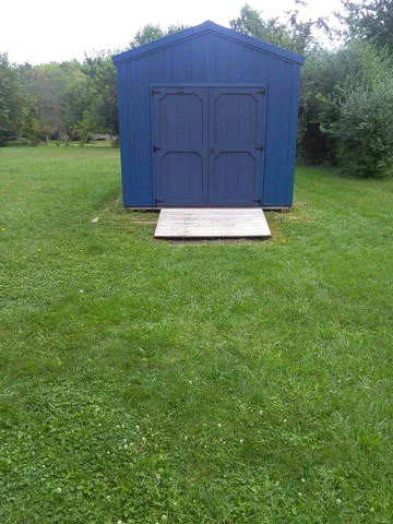 a view of a small yard with wooden fence