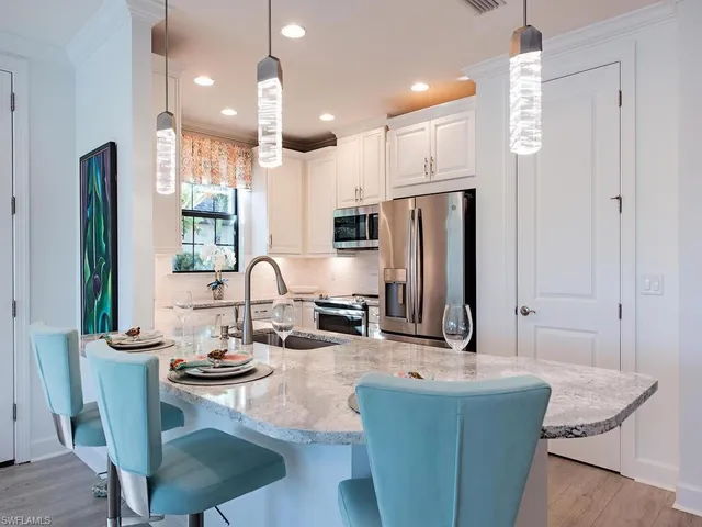 a view of kitchen with kitchen island and stainless steel appliances