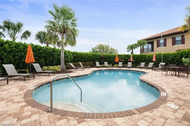 a view of a swimming pool with chairs