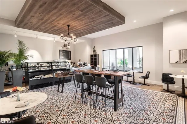 a view of a dining room with furniture wooden floor and chandelier