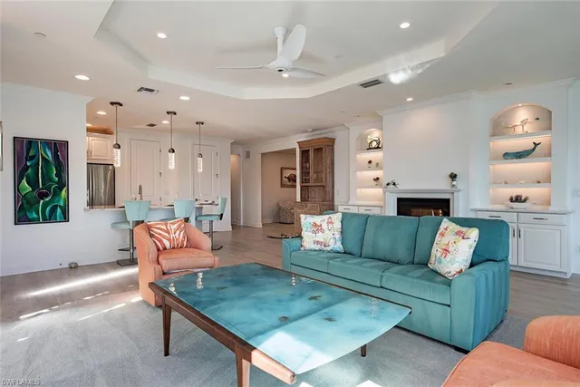 a living room with fireplace furniture and a large window