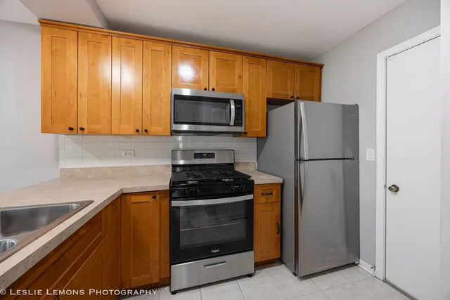 a kitchen with a refrigerator stove and microwave