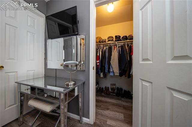 7511 Coffee Road Peyton, CO 80831 - Photo 29 of 38 Walk in closet with wood finished floors