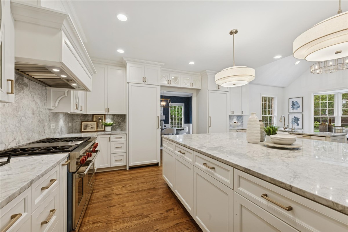 628 South County Line Road Hinsdale, IL 60521 - Photo 11 of 34 a kitchen with granite countertop kitchen island white cabinets and stainless steel appliances