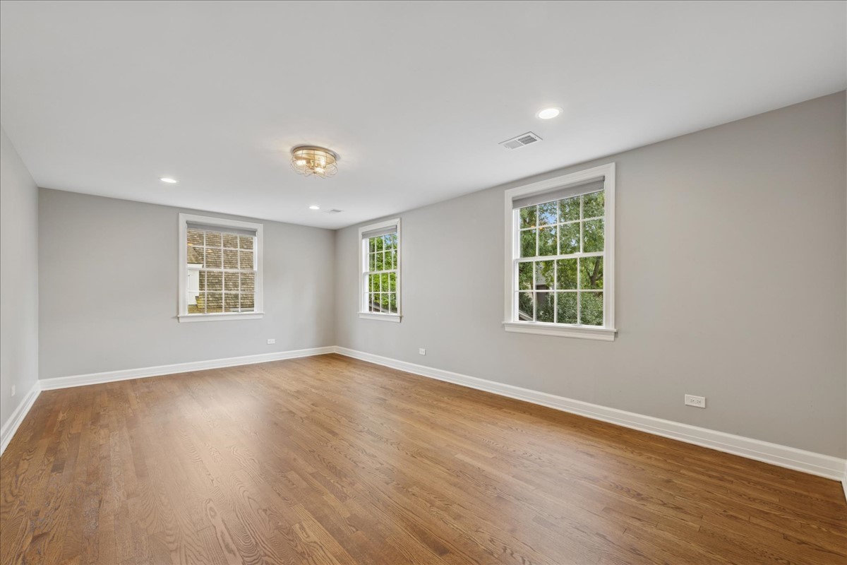 628 South County Line Road Hinsdale, IL 60521 - Photo 22 of 34 a view of an empty room with wooden floor and a window