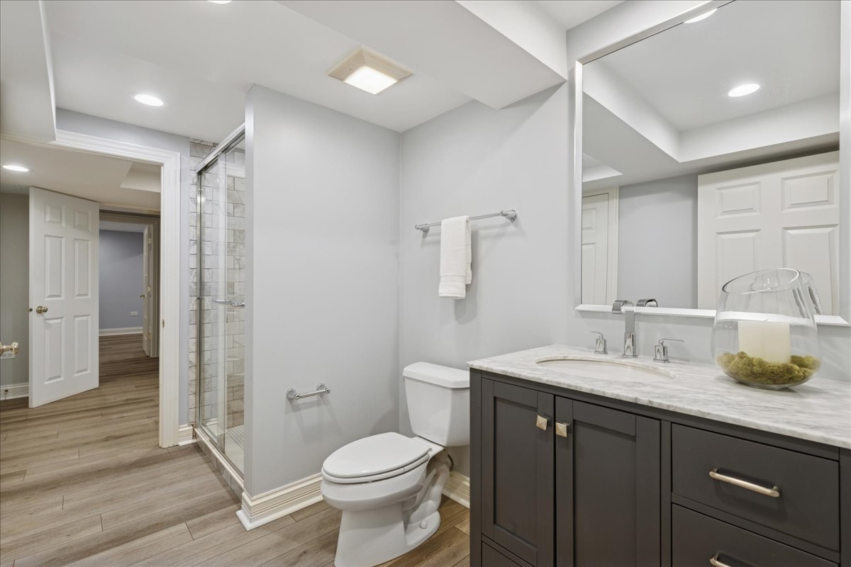 628 South County Line Road Hinsdale, IL 60521 - Photo 26 of 34 a bathroom with a granite countertop sink toilet and shower
