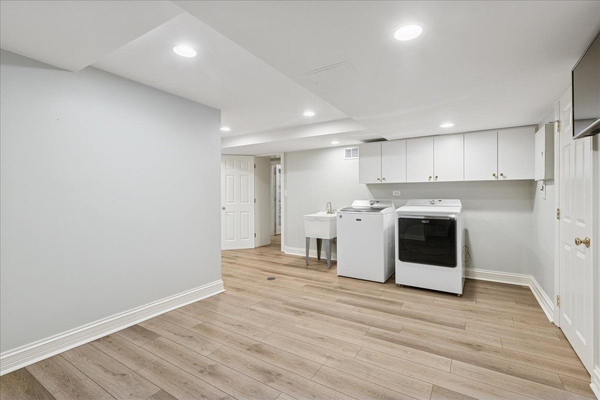 628 South County Line Road Hinsdale, IL 60521 - Photo 27 of 34 a view of a kitchen with stainless steel appliances wooden floor and large windows