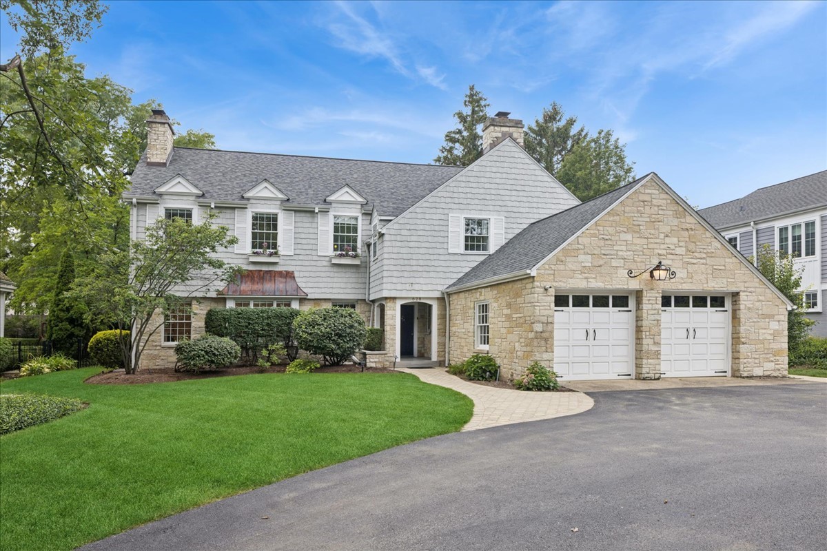 628 South County Line Road Hinsdale, IL 60521 - Photo 30 of 34 a view of a white house next to a yard and potted plants