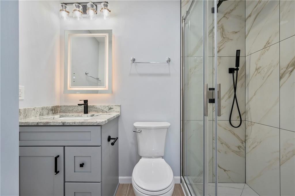 26 Yoder Street Pittsburgh, PA 15207 - Photo 13 of 30 a bathroom with a granite countertop sink toilet and shower