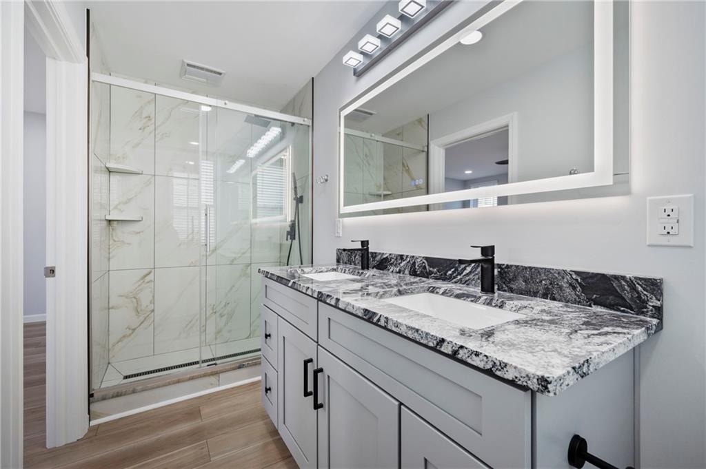 26 Yoder Street Pittsburgh, PA 15207 - Photo 18 of 30 a bathroom with a granite countertop sink and a mirror