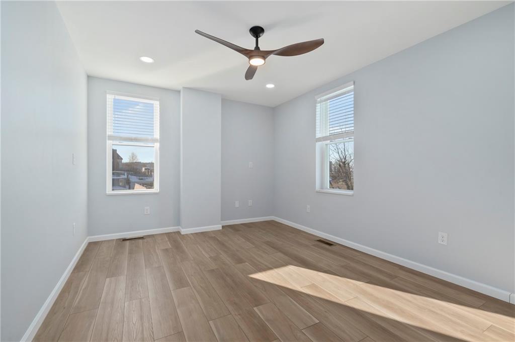 26 Yoder Street Pittsburgh, PA 15207 - Photo 22 of 30 wooden floor in an empty room with a window