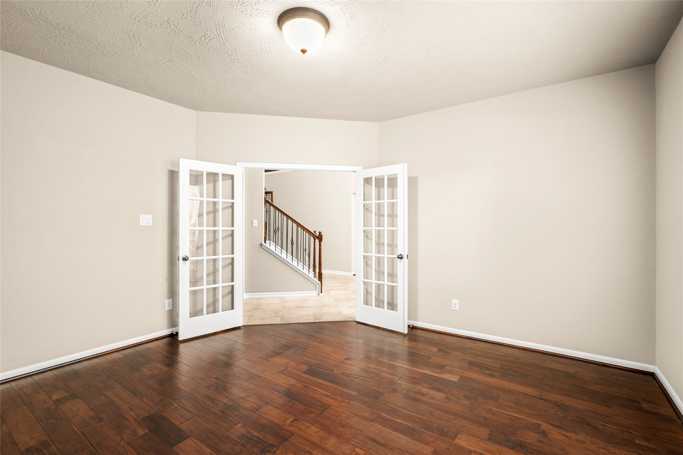 5307 Amber Sky Lane Rosharon, TX 77583 - Photo 8 of 50 Generous in scale and bright throughout, this homeoffice boasts gleaming wood floors, French doors, and a view to the staircase beyon. A versatile space ready for your vision.