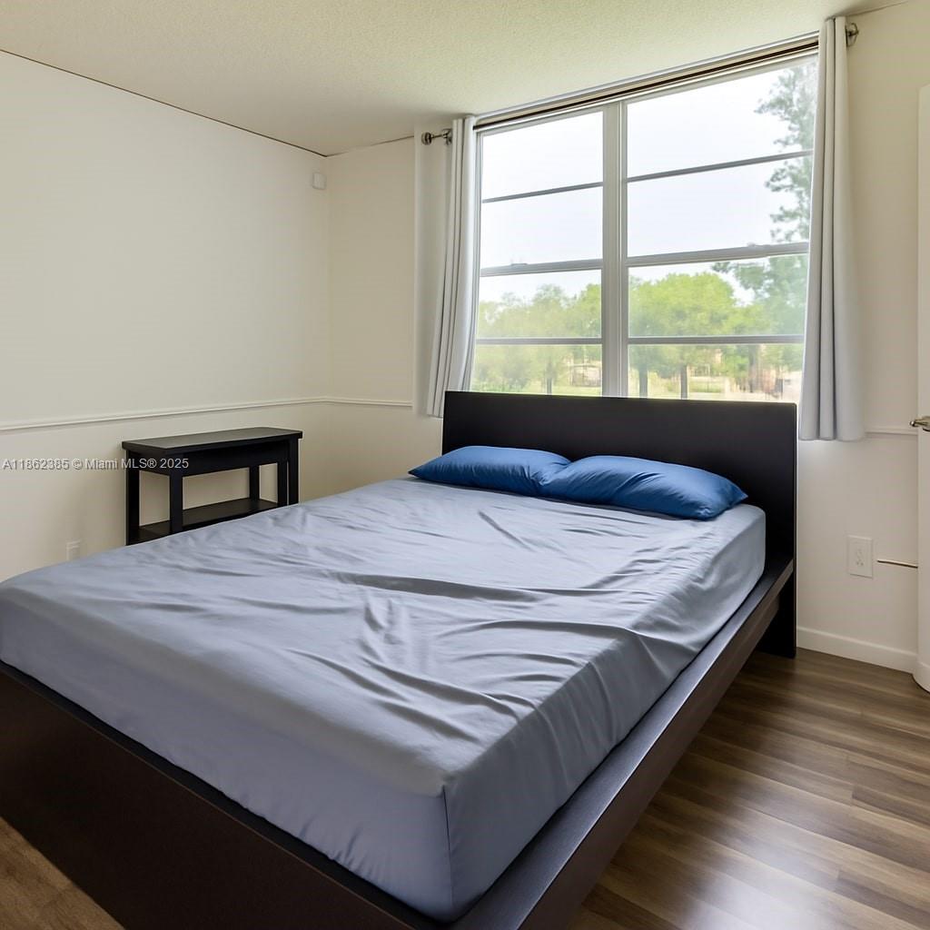 9330 Lagoon Place, Unit 206 Davie, FL 33324 - Photo 11 of 17 a bedroom with a bed and a window