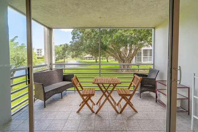 a view of chairs and table in patio with a yard