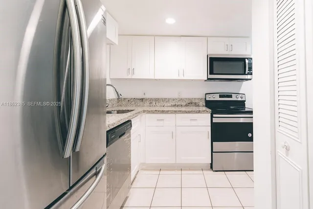 a kitchen with a sink and a stove top oven