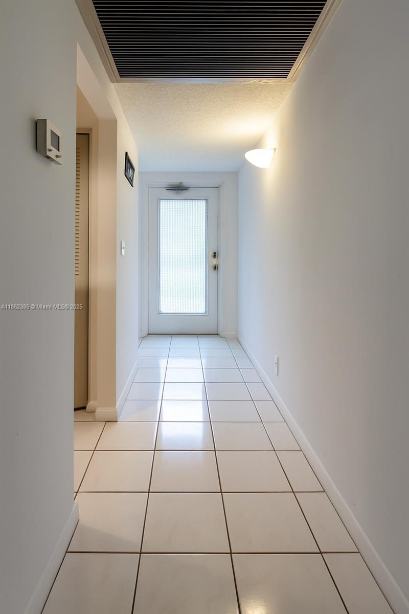 9330 Lagoon Place, Unit 206 Davie, FL 33324 - Photo 5 of 17 a view of empty room with white walls