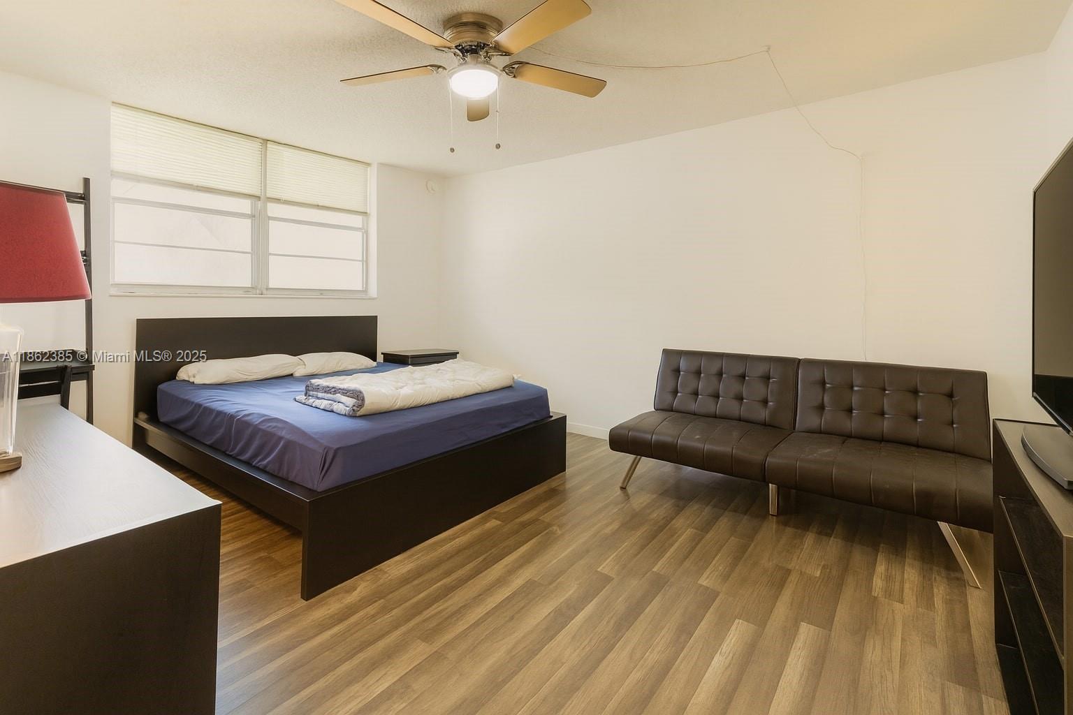 9330 Lagoon Place, Unit 206 Davie, FL 33324 - Photo 7 of 17 a living room with a bed furniture and a window