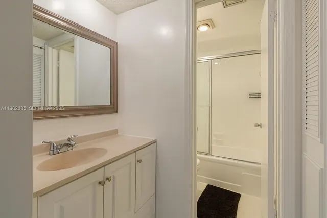 a bathroom with a sink vanity and a mirror