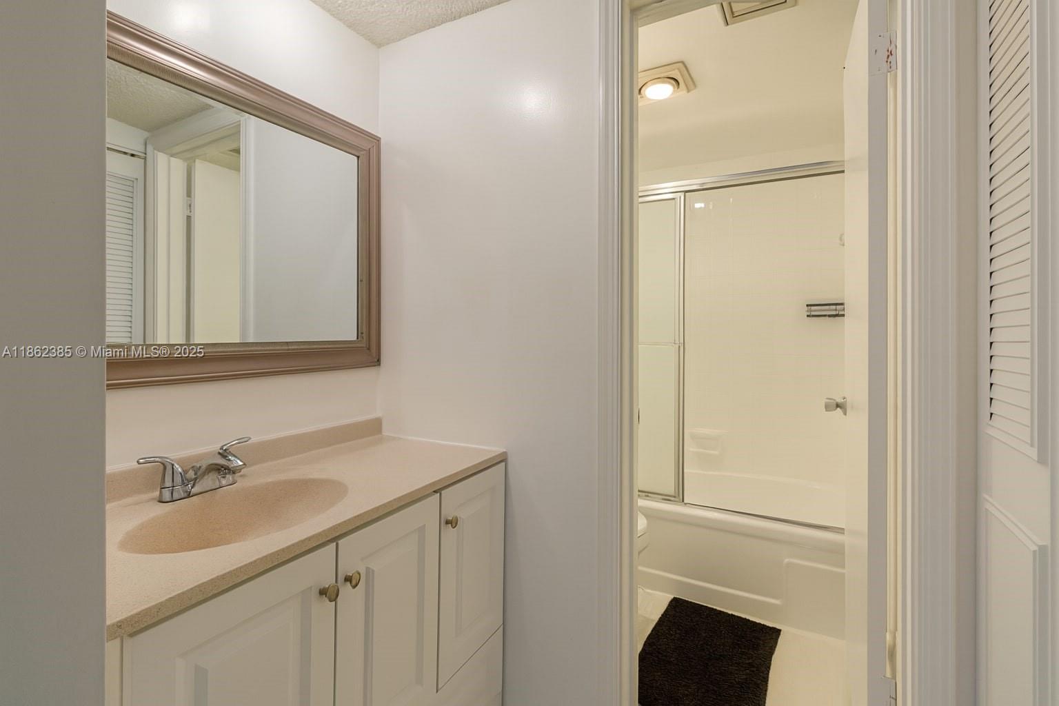 9330 Lagoon Place, Unit 206 Davie, FL 33324 - Photo 8 of 17 a bathroom with a sink and a mirror